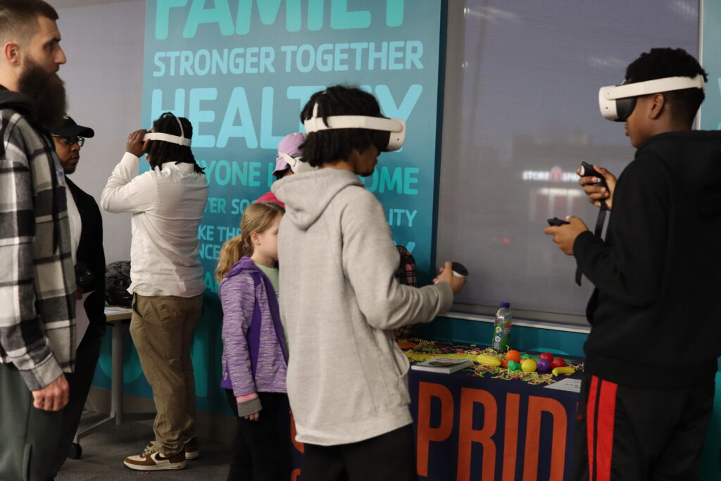 Children wearing VR headsets explore virtual spaces at an FSLsci event.