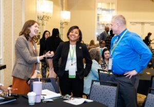 Families Learning Conference attendees talking during a session