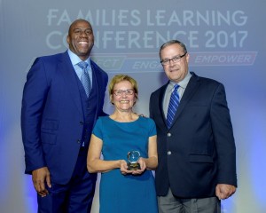 2017 Toyota Family Teacher of the Year Mary Andrews accepts the award from Earvin "Magic" Johnson, SodexoMAGIC and Mike Goss, general manager, Toyota Social Innovation
