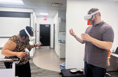 A parent participant and an NCFL staff member interact in virtual reality using headsets