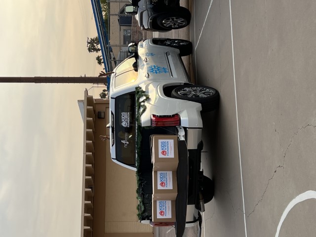 A Toyota Tundra is parked with school supply boxes from Kids In Need Foundation in the truck bed.