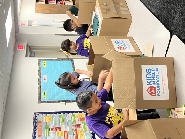 Students unboxing their new school supplies.
