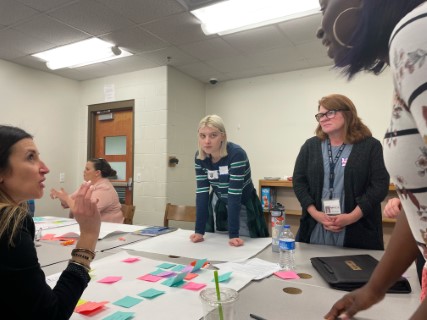 At a recent convening in Scott County, Kentucky, high school student Emily listens closely to teachers and parents so that she can capture their thoughts during her facilitation of the elementary design team. Emily explained that current individualized learning plan options are not giving students the career exploration experiences they need to make informed college and career decisions.